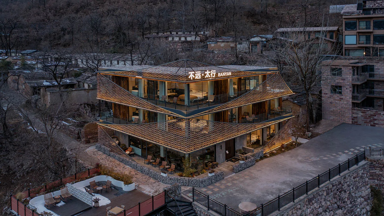 A large modern building with a unique design featuring a combination of stone and wood elements, well-lit with natural light from the windows