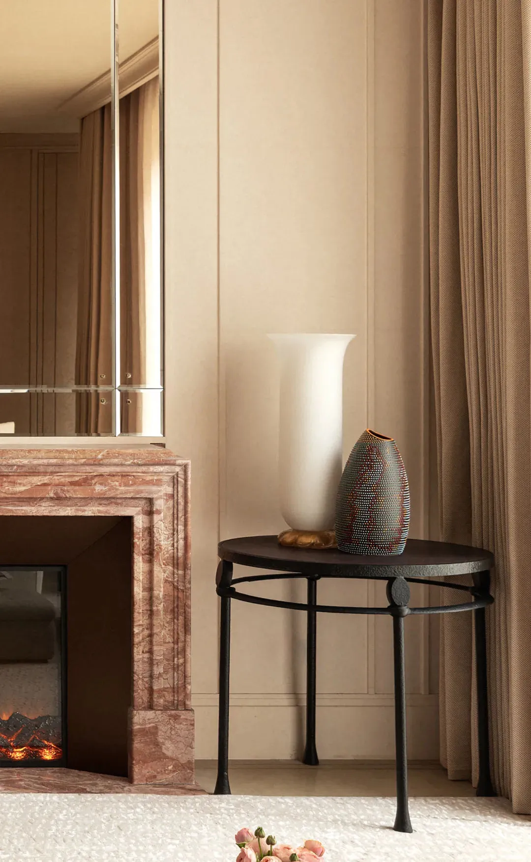 A modern room with a white wall, a brown table, a mirror, and a vase, featuring a clean and minimalist design, well-lit with a calm and serene atmosphere