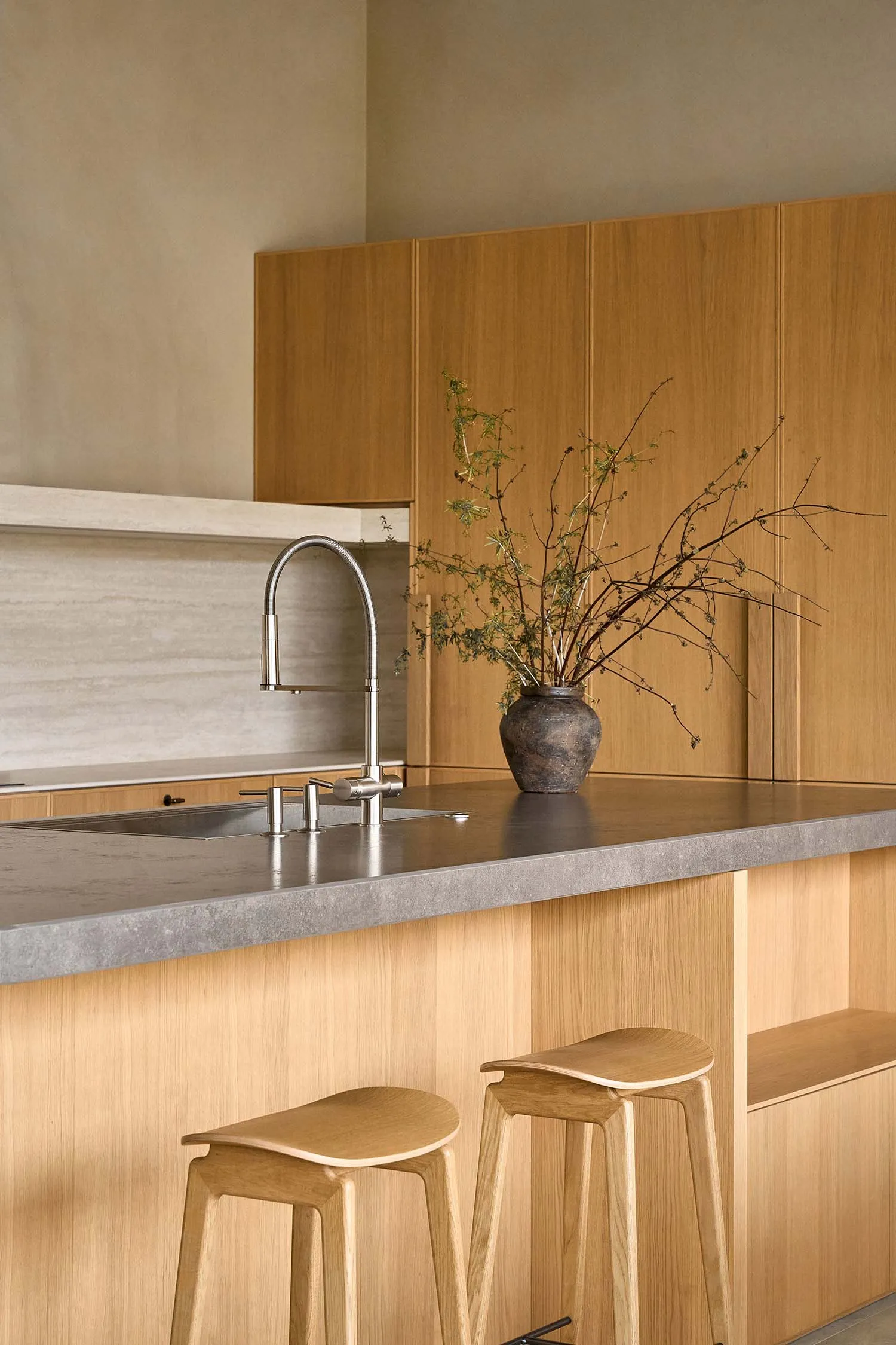 Warm and inviting kitchen with wooden cabinets, marble countertop, and natural elements