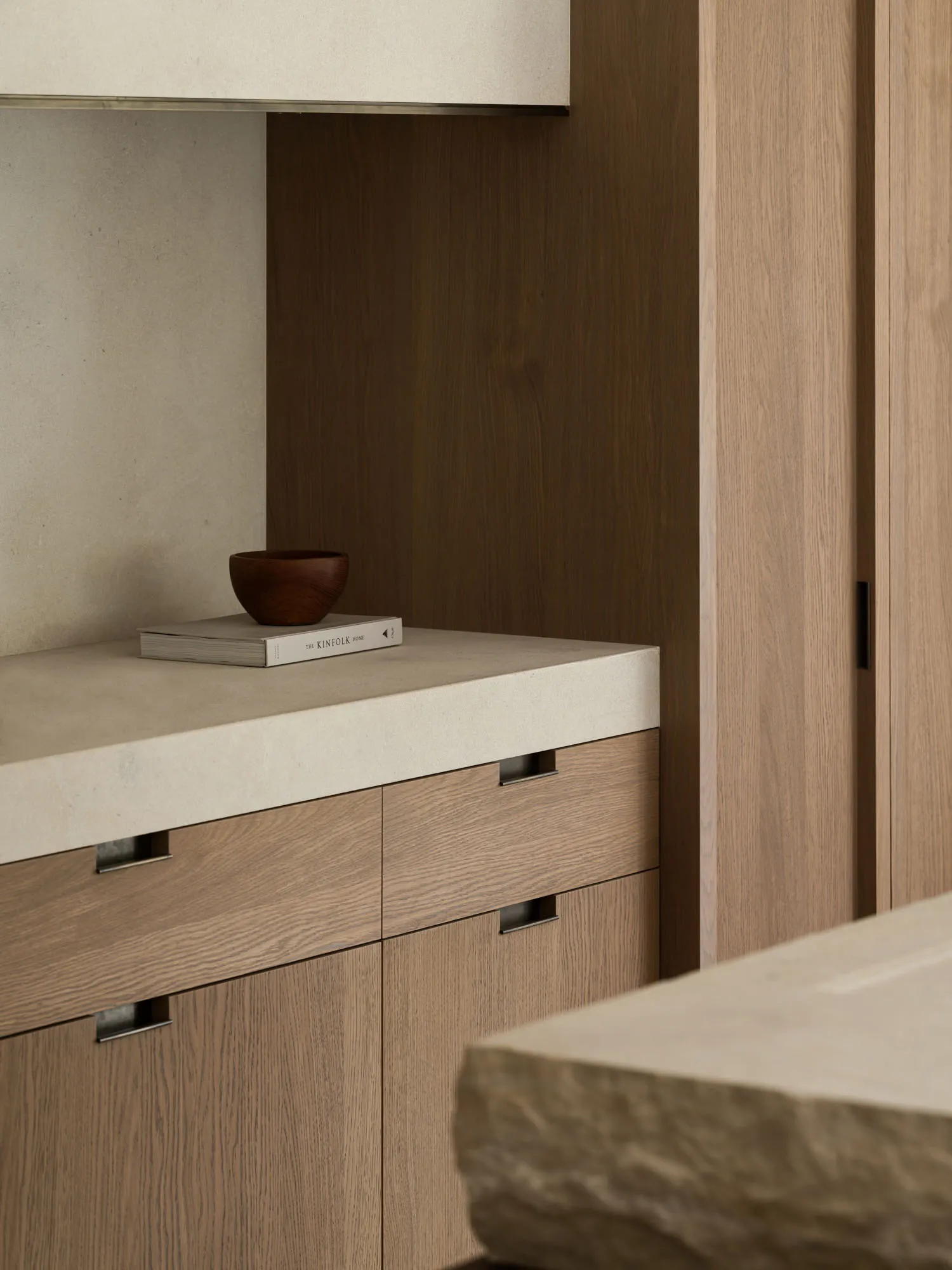 A modern kitchen with wooden cabinets and a stone countertop, creating a warm and inviting atmosphere