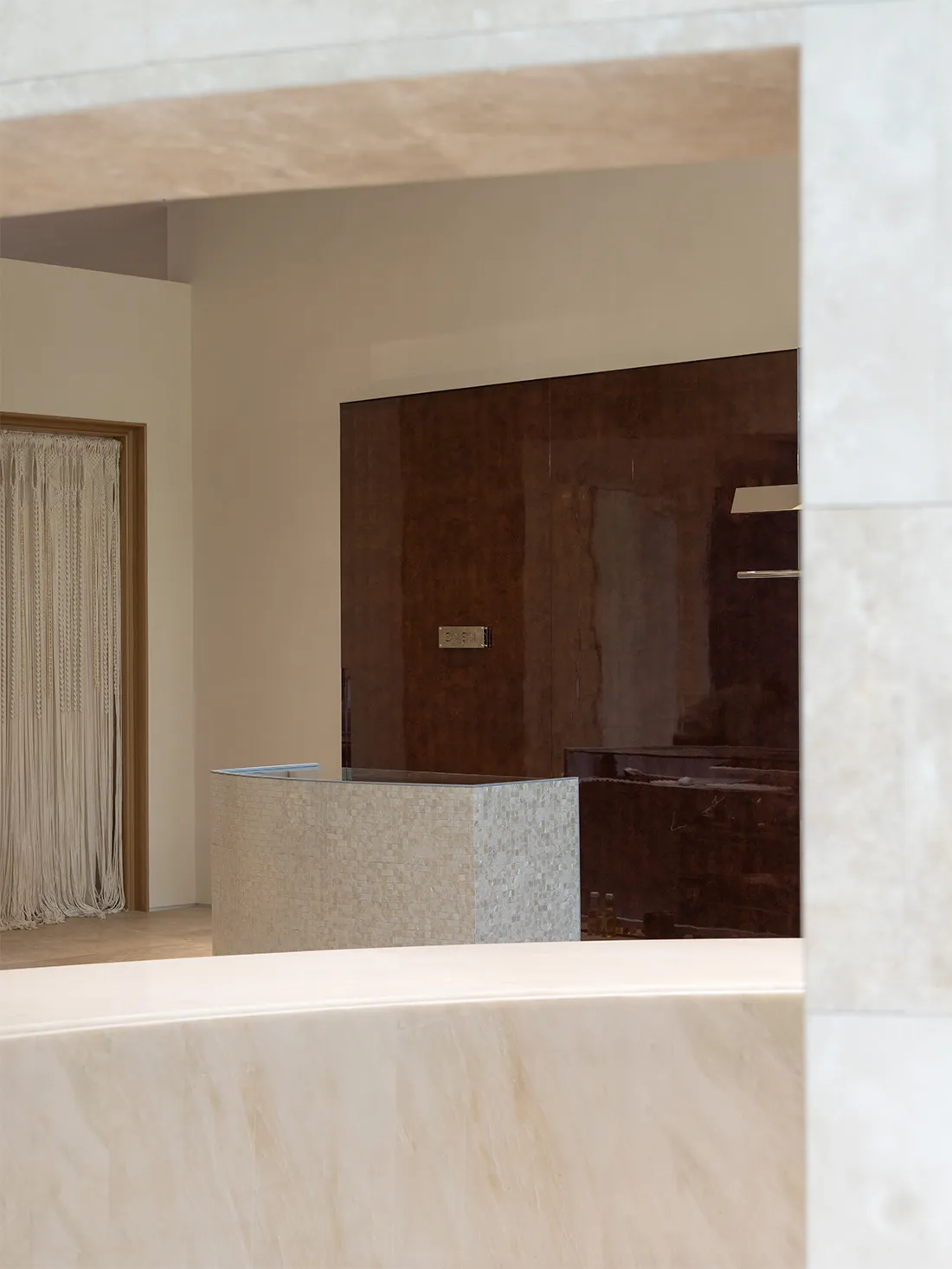 Bathroom with a marble countertop, sink, and mirror in a well-lit space