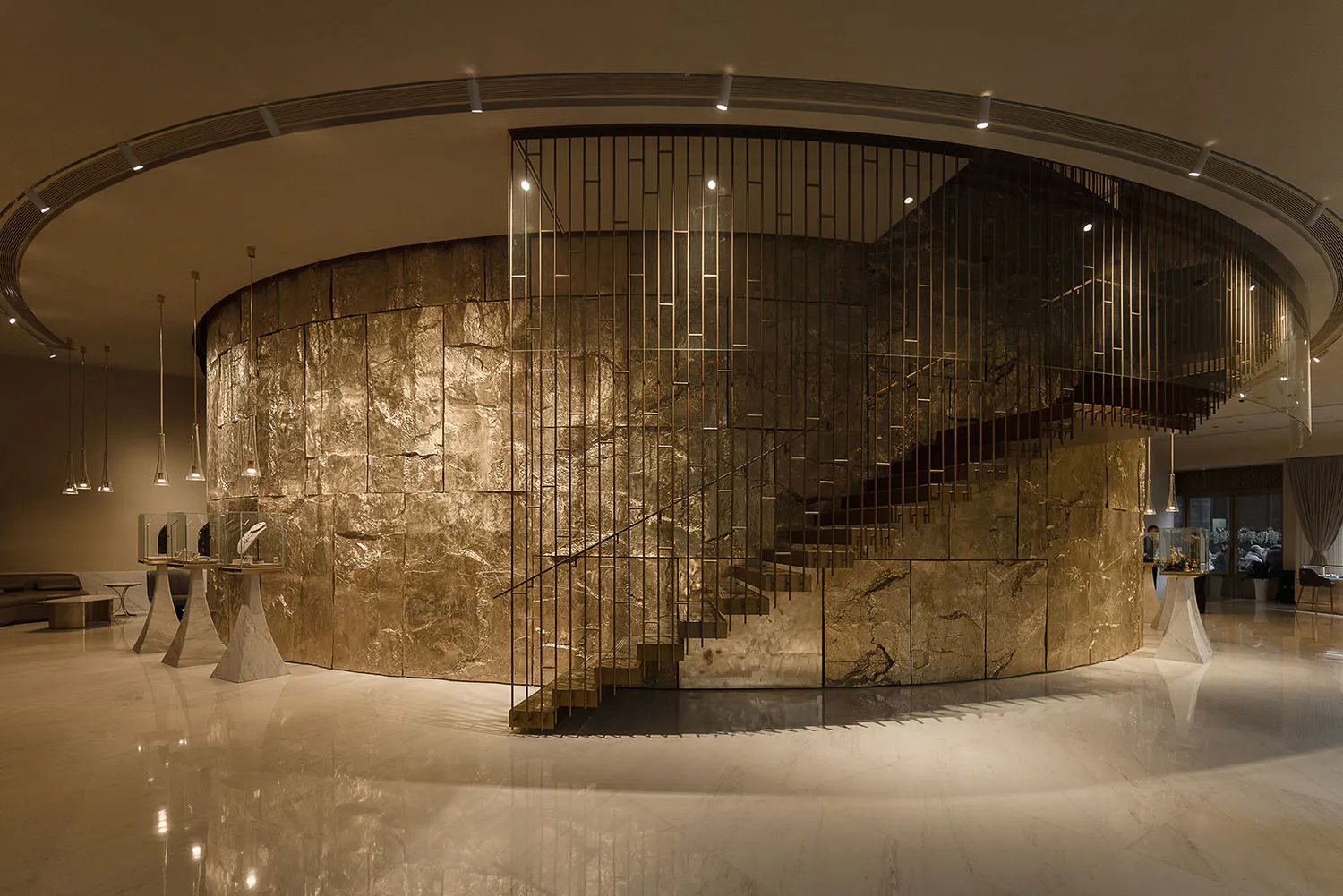 A grand marble staircase with a metal railing in a well-lit hallway, captured from a low angle to emphasize its height and grandeur