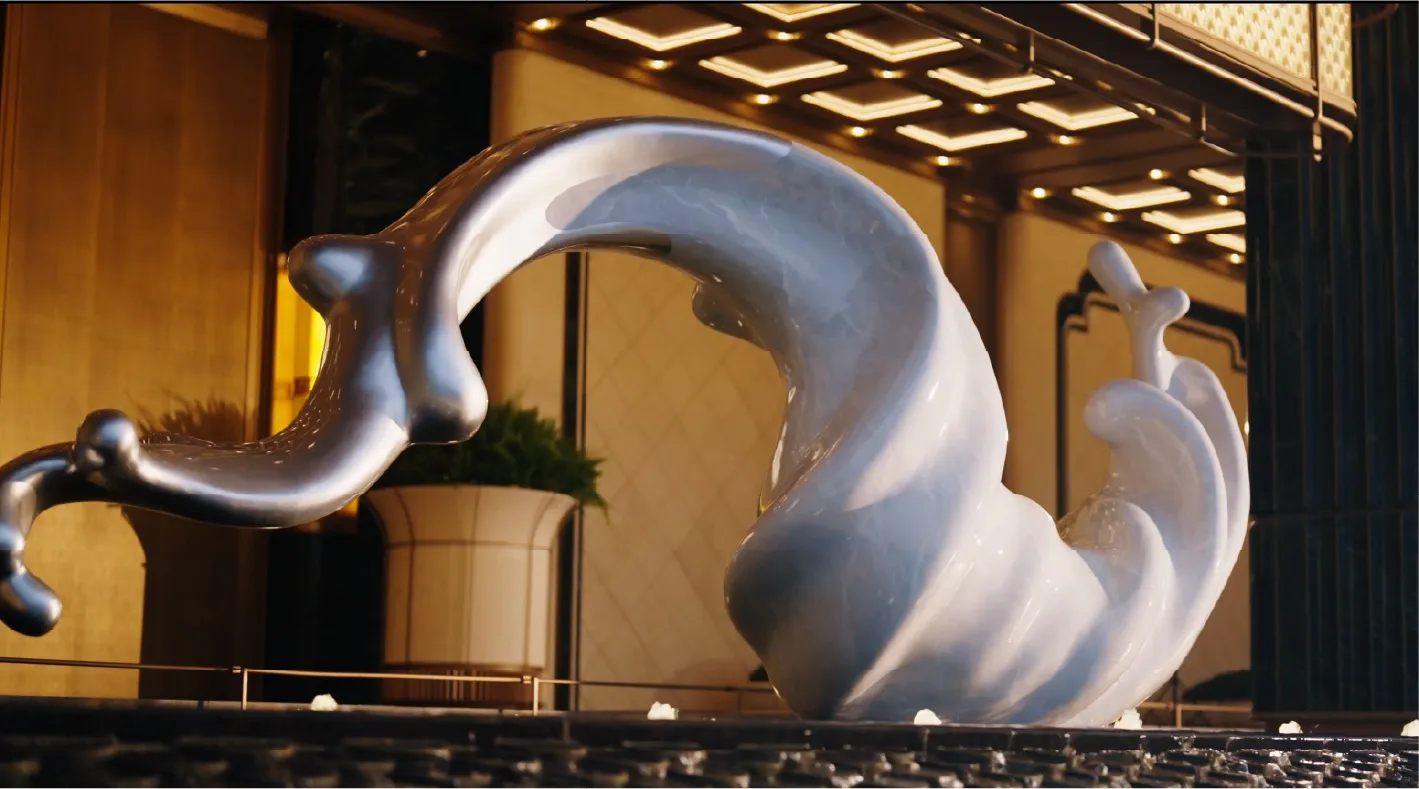 A modern metal sculpture is placed in a museum or art gallery setting with a potted plant nearby, illuminated by natural sunlight