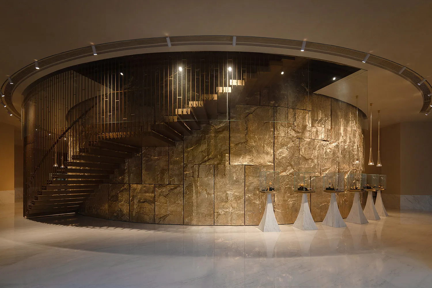 A bright and inviting lobby with a marble staircase, clean lines, and minimalistic design elements