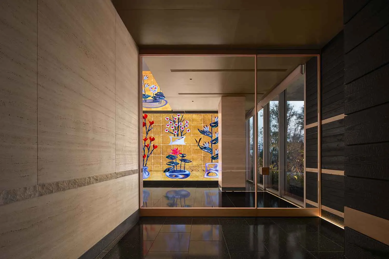 A modern room with a black and white tile floor, a large window, a door, and a wall with a colorful painting of flowers in a dimly lit space