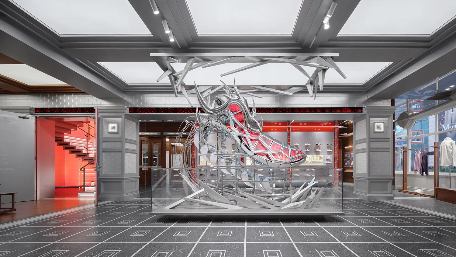 A modern shoe store with a large metal shoe sculpture as the centerpiece, surrounded by a glass display case and sleek interior design