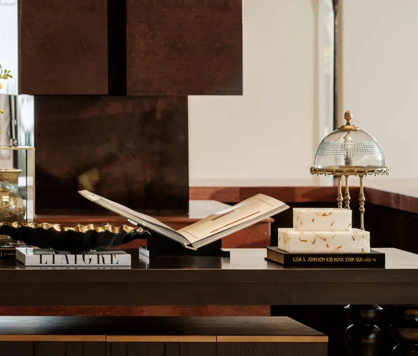 A cozy kitchen with a wooden counter, two books, a cake, and a bowl, creating a warm and inviting atmosphere