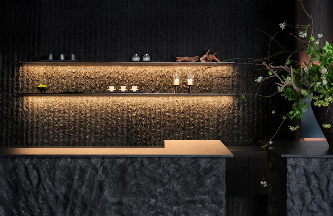 Elegant kitchen with a marble countertop, candles, a vase, and a bowl, creating a sophisticated atmosphere