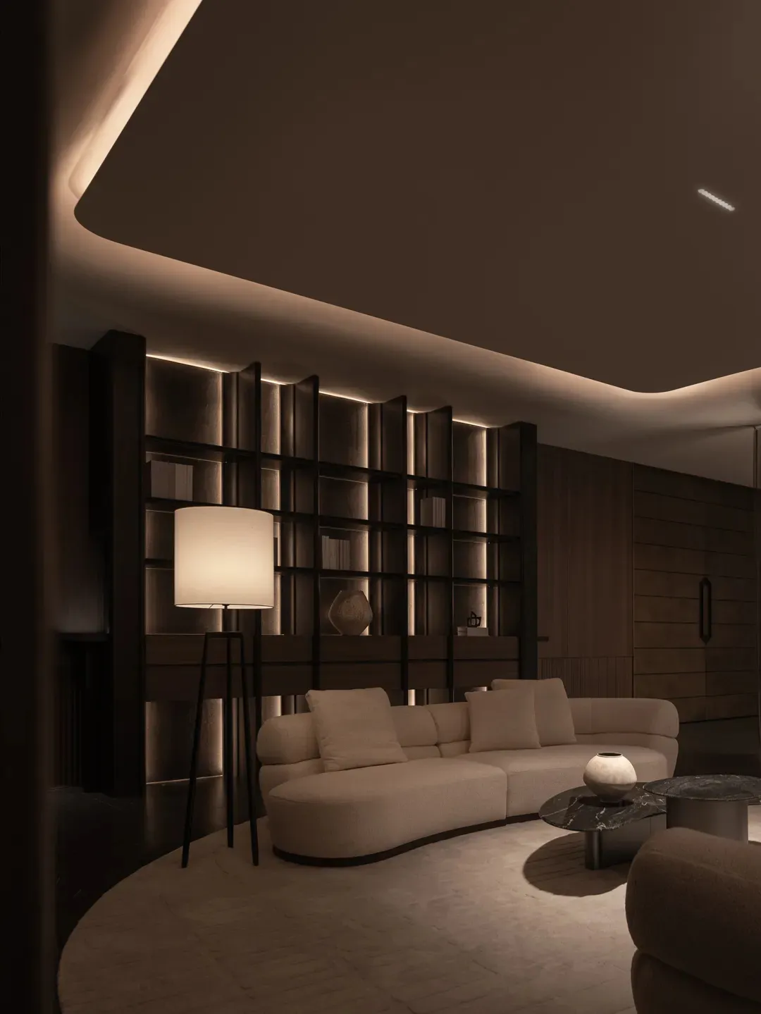 Cozy living room with white furniture, a bookshelf, and warm lighting