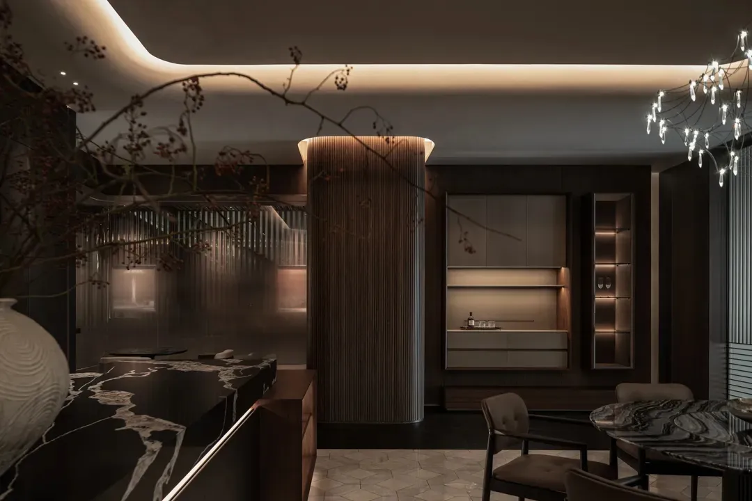 A well-lit modern kitchen with wooden cabinets, a dining table, and chairs, surrounded by natural materials and clean design elements