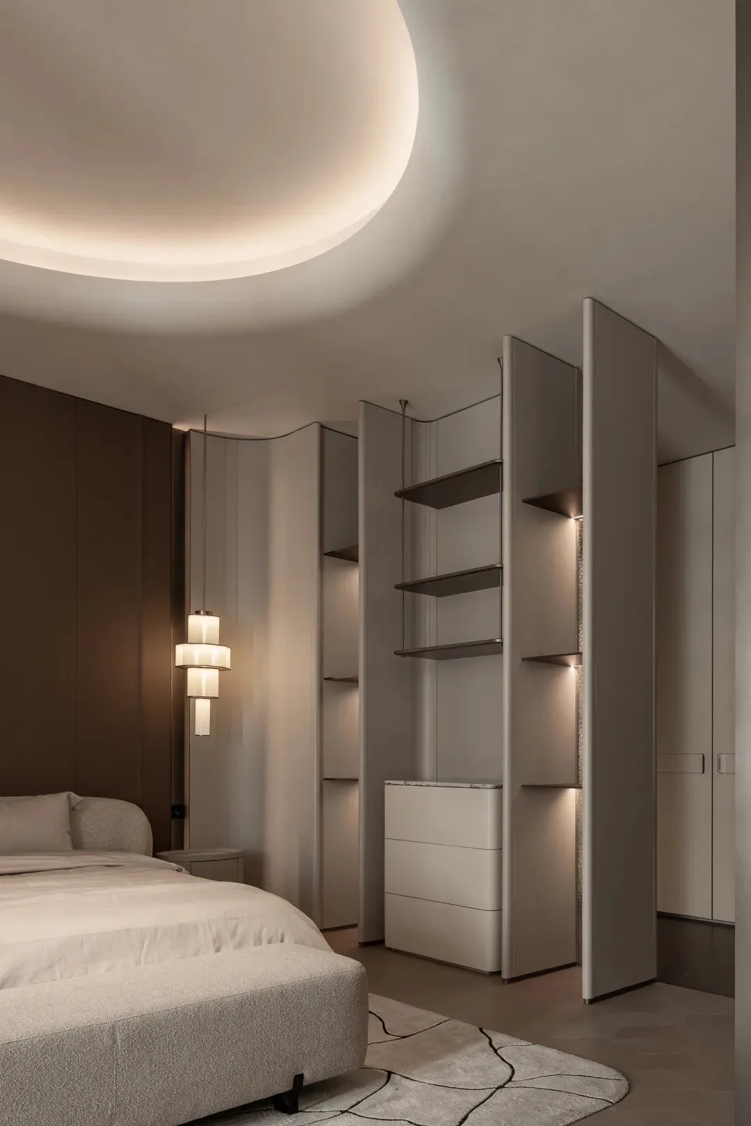 A well-lit bedroom with a bed, dresser, and bookshelf, creating a comfortable and inviting atmosphere