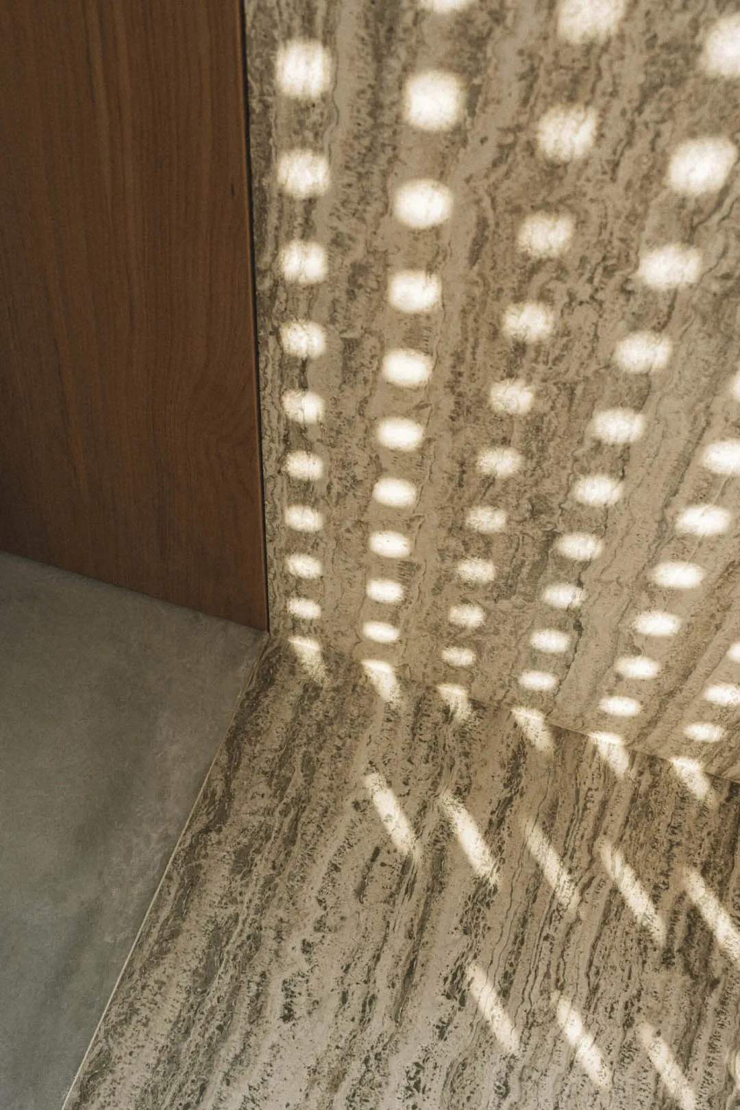 Cozy hallway with a wooden door, marble floor, and dim lighting