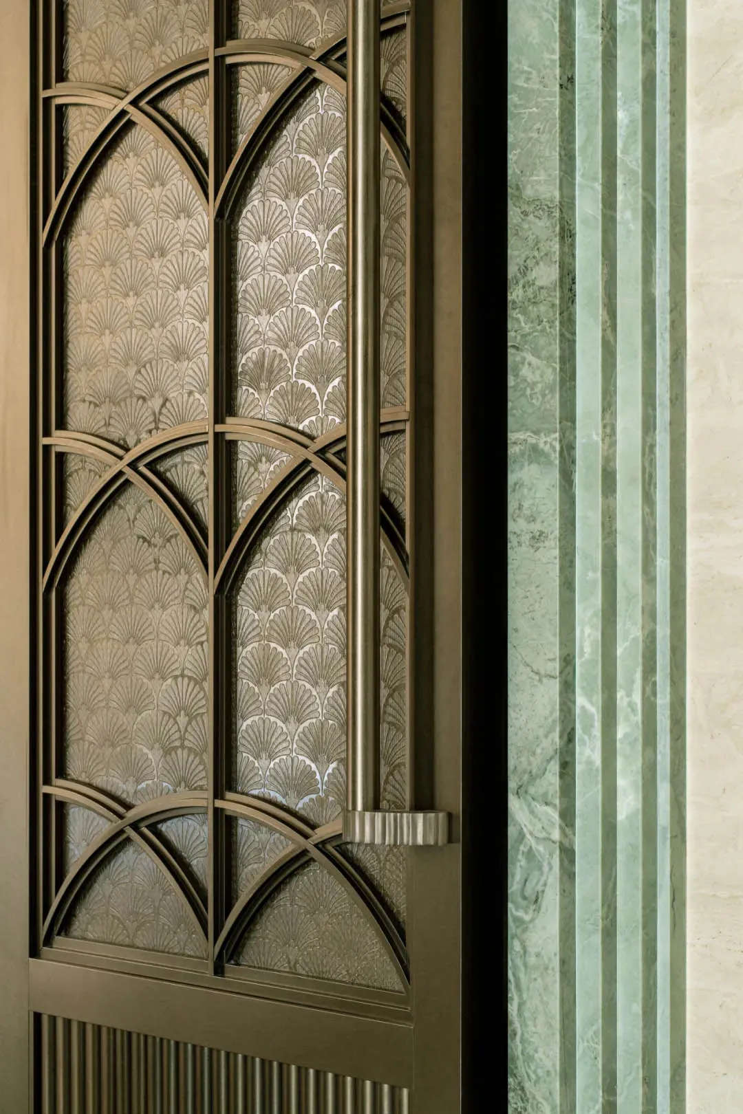 A doorway with a glass window and metal frame, set against a green and white background, adorned with decorative design elements