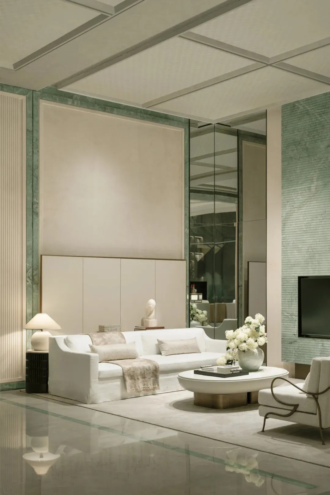 A well-lit modern living room with white furniture, a large window, and natural light