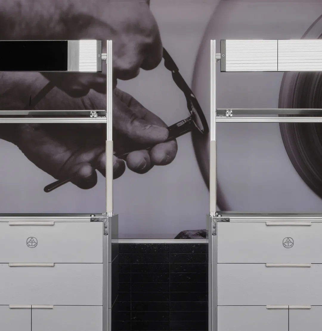A professional workspace with two gray modern filing cabinets against a wall, one on the left and one on the right, with a person possibly working or organizing the space