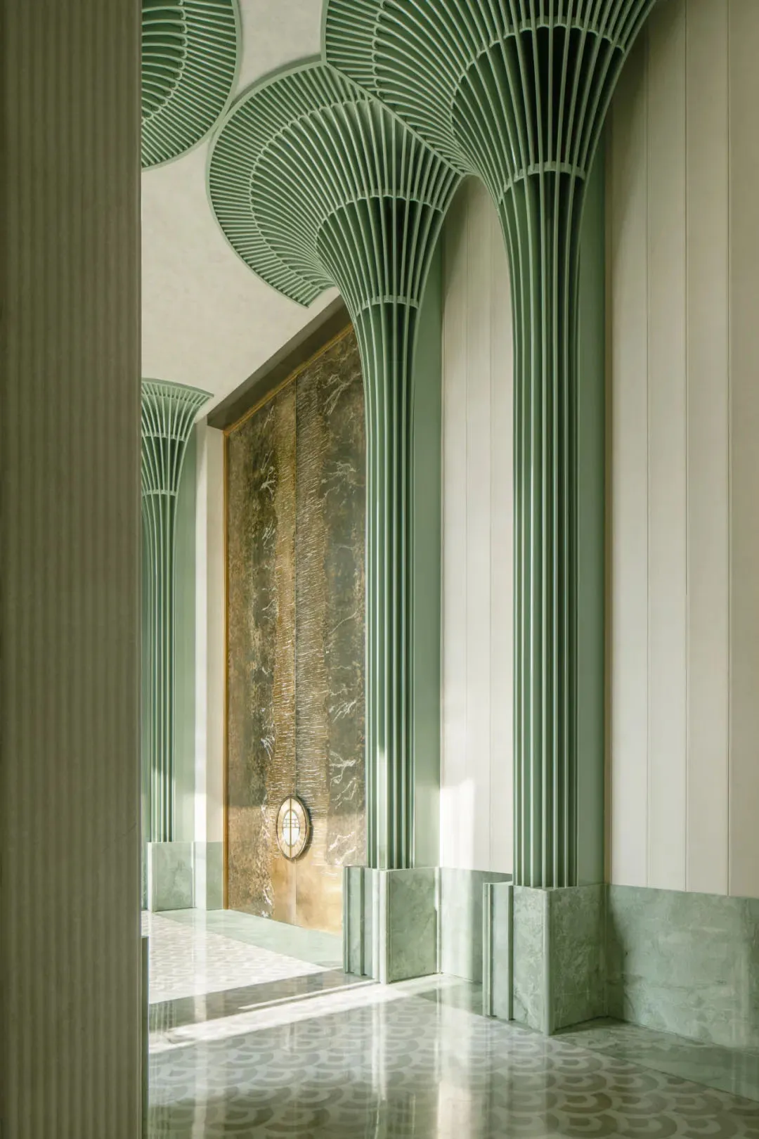 A luxurious living space with a green and white color scheme, featuring a marble wall, decorative elements, and soft warm lighting
