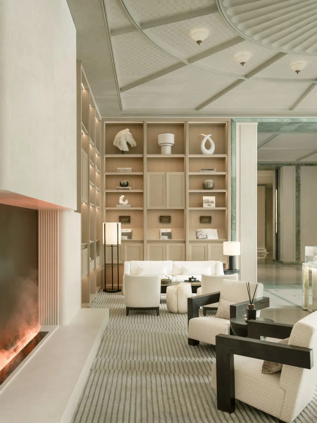 Cozy living room with a fireplace, modern furniture, and soft warm lighting