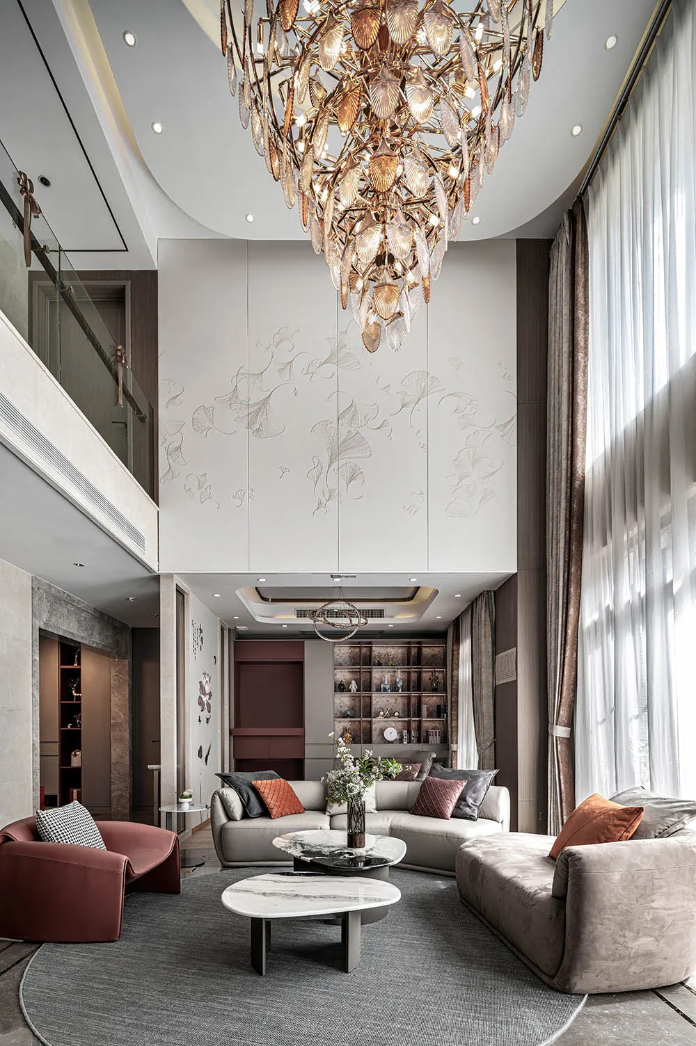 Cozy modern living space with a chandelier, vases, plants, and comfortable furniture