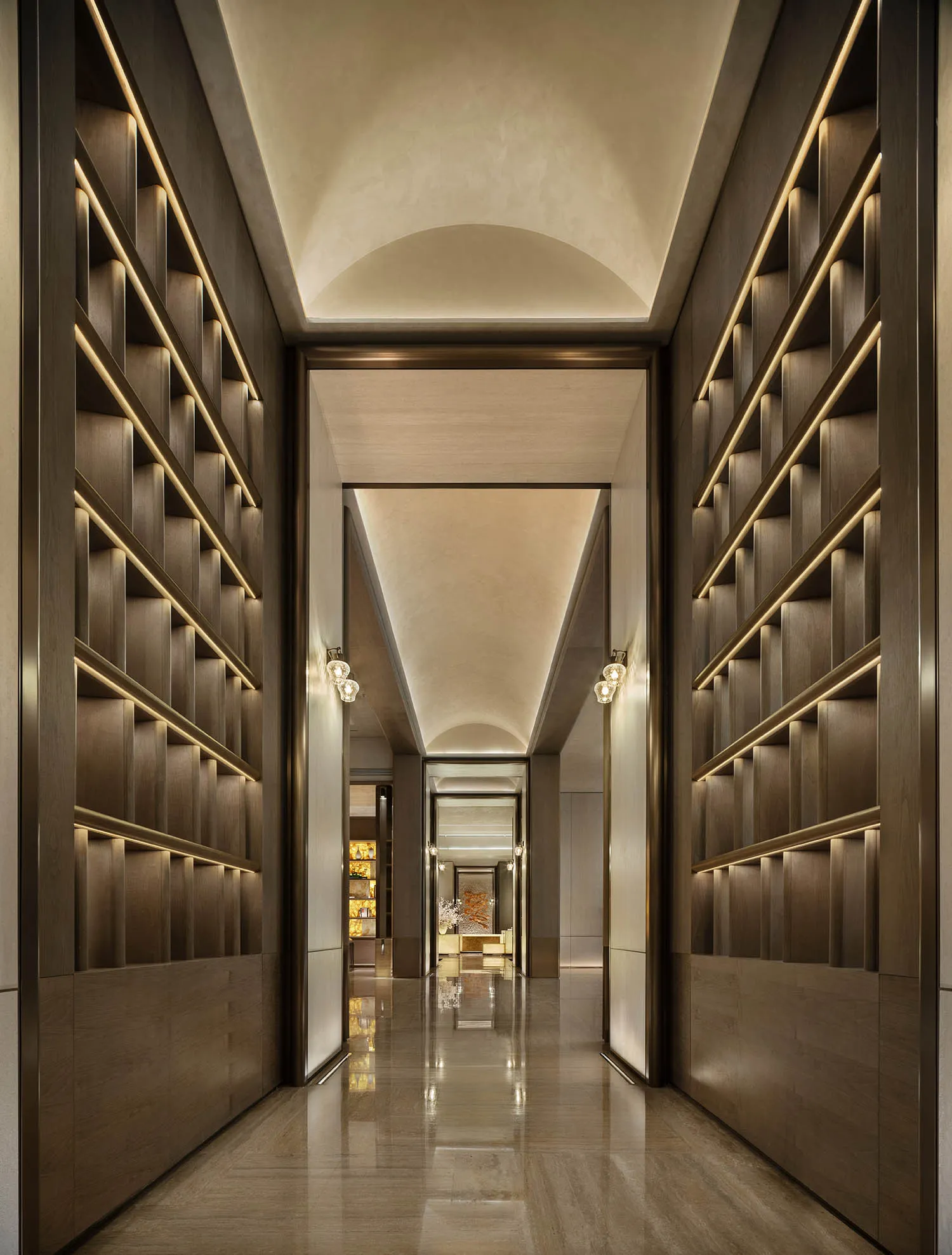 A well-lit hallway with bookshelves lining the walls, filled with books, creating a cozy and intellectual atmosphere