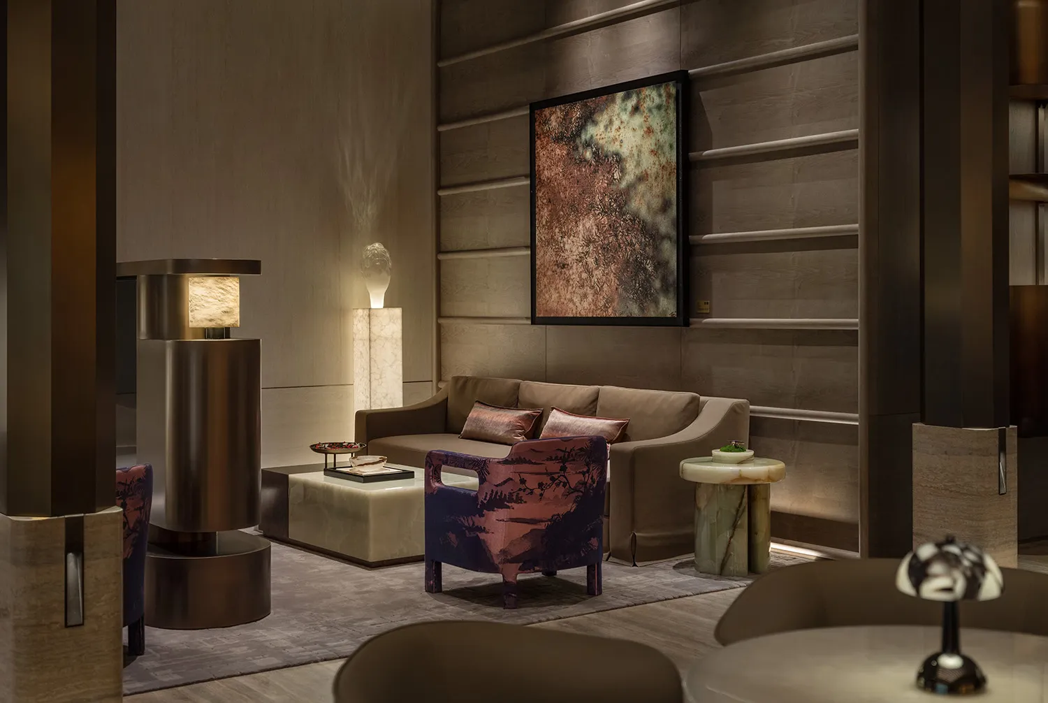 Cozy modern living space with a brown couch, wooden floor, and soft warm lighting