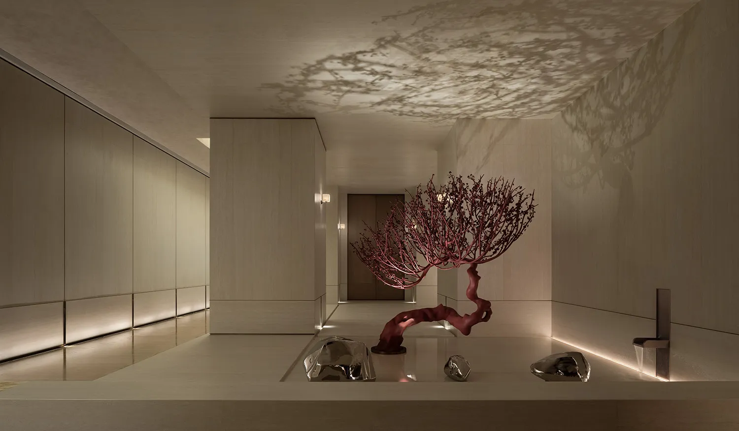 A modern room with white walls, a red tree-like sculpture, and natural light from windows