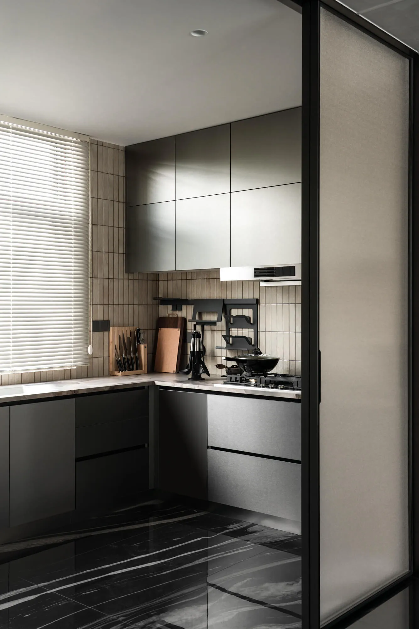 Modern minimalist kitchen interior with dark grey handleless cabinets, white marble countertops, black marble floor tiles, and wood slat accent wall beside a window with white blinds.