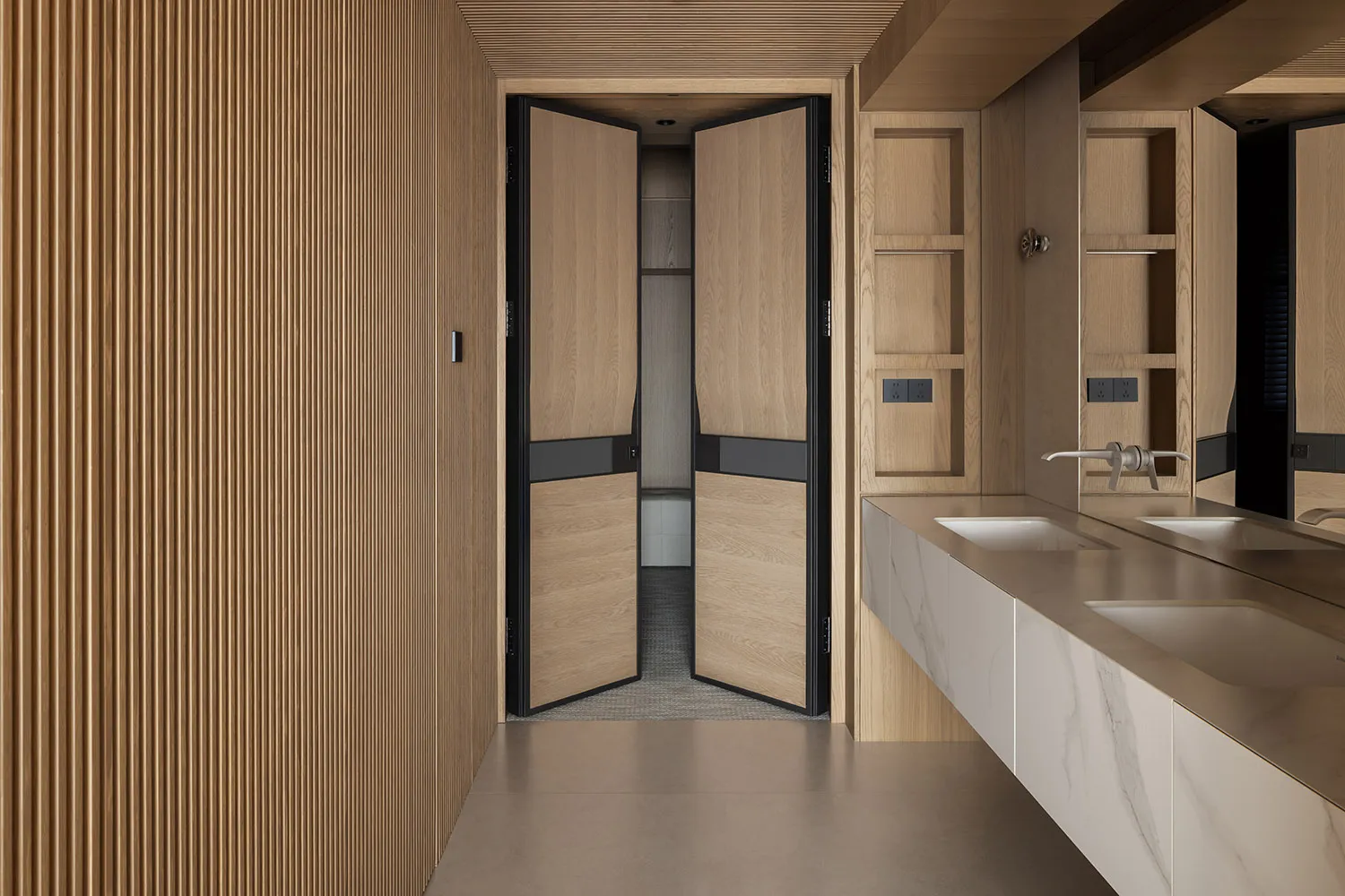 Modern minimalist bathroom interior with double white marble sinks, oak vanity, large mirror, and a prominent light oak fluted wood wall panel on the left.