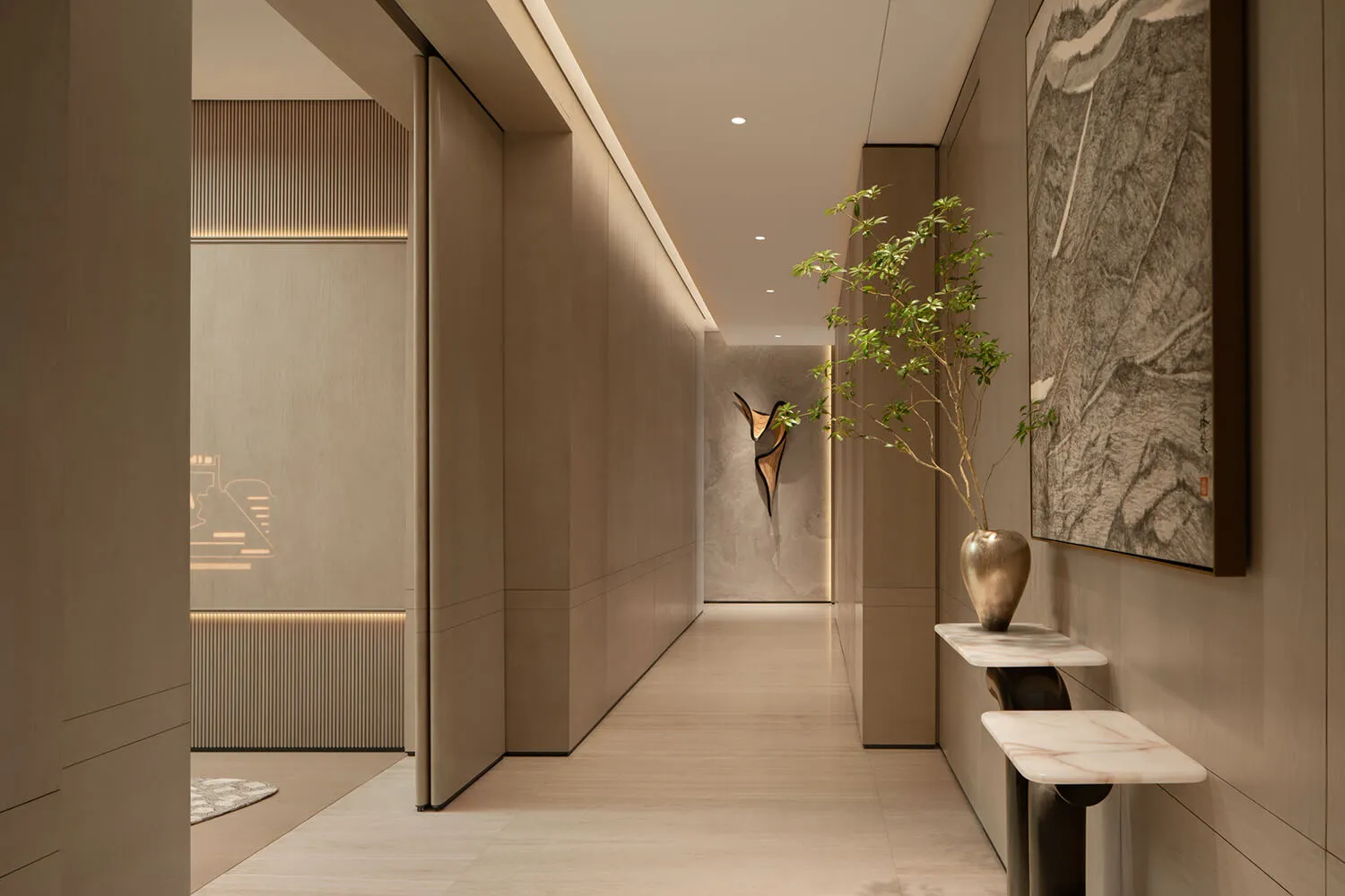 Modern minimalist hallway featuring light wood paneling, recessed lighting, marble console table with bronze vase and potted tree, and large Chinese ink painting on the wall.