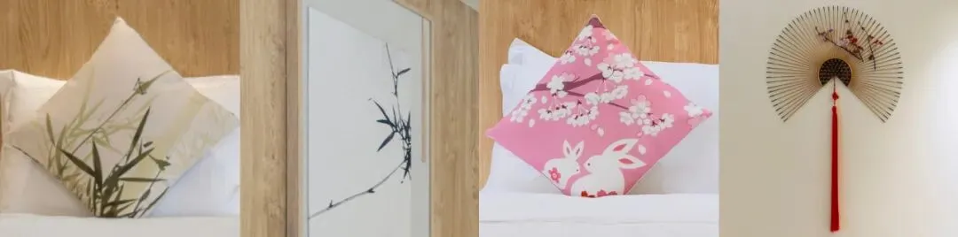 Four decorative elements arranged side by side: a white pillow with green bamboo print, a framed ink painting of bamboo, a pink cherry blossom pillow with rabbit motif, and a traditional Japanese paper fan with red tassel.