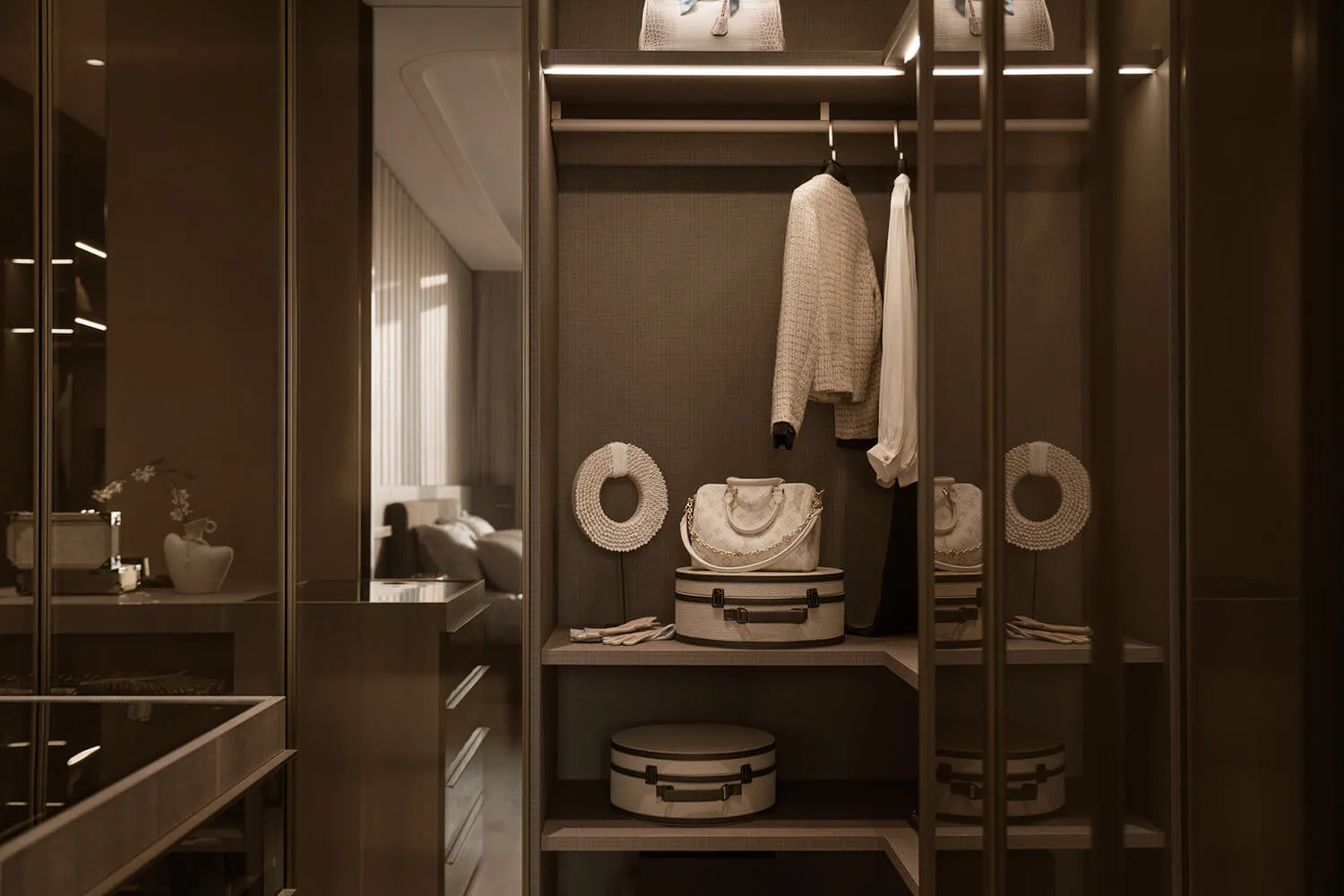 Modern walk-in closet with neutral beige and taupe palette, built-in LED strip lighting, open shelving displaying designer handbags, hats, and clothing, with glass doors reflecting a bedroom in the background.