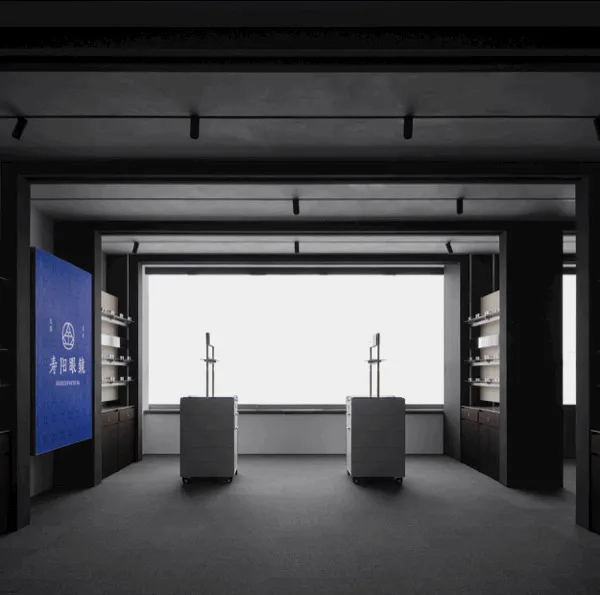 Minimalist concrete retail gallery interior with two central floating display cabinets, built-in shelving, large panoramic window, and blue brand wall for Shouyang Gallery.