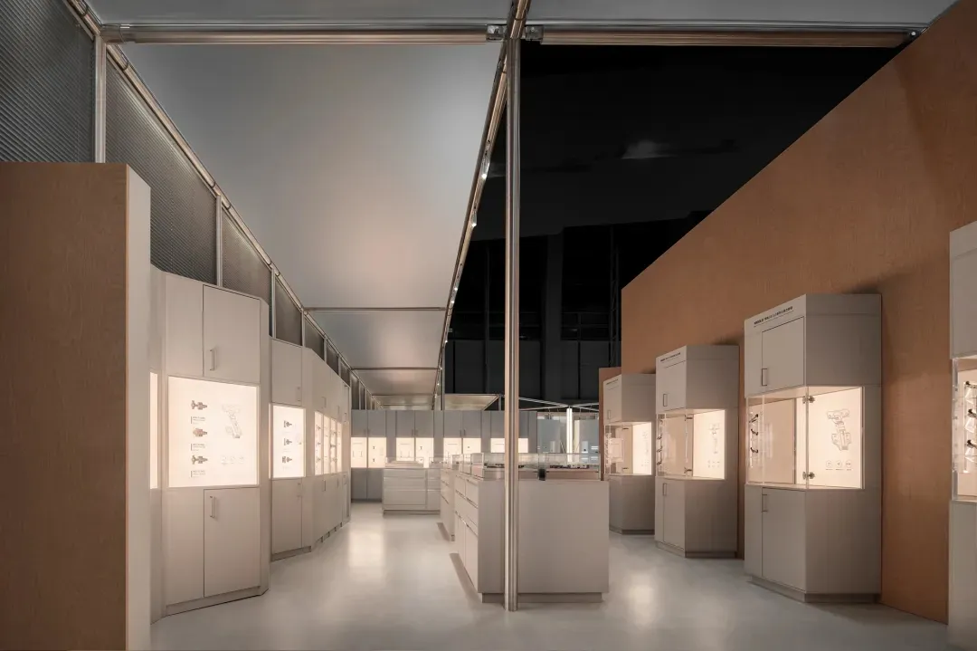 Modern minimalist jewelry store interior with oak paneling, white display cabinets, and integrated LED lighting illuminating jewelry pieces.