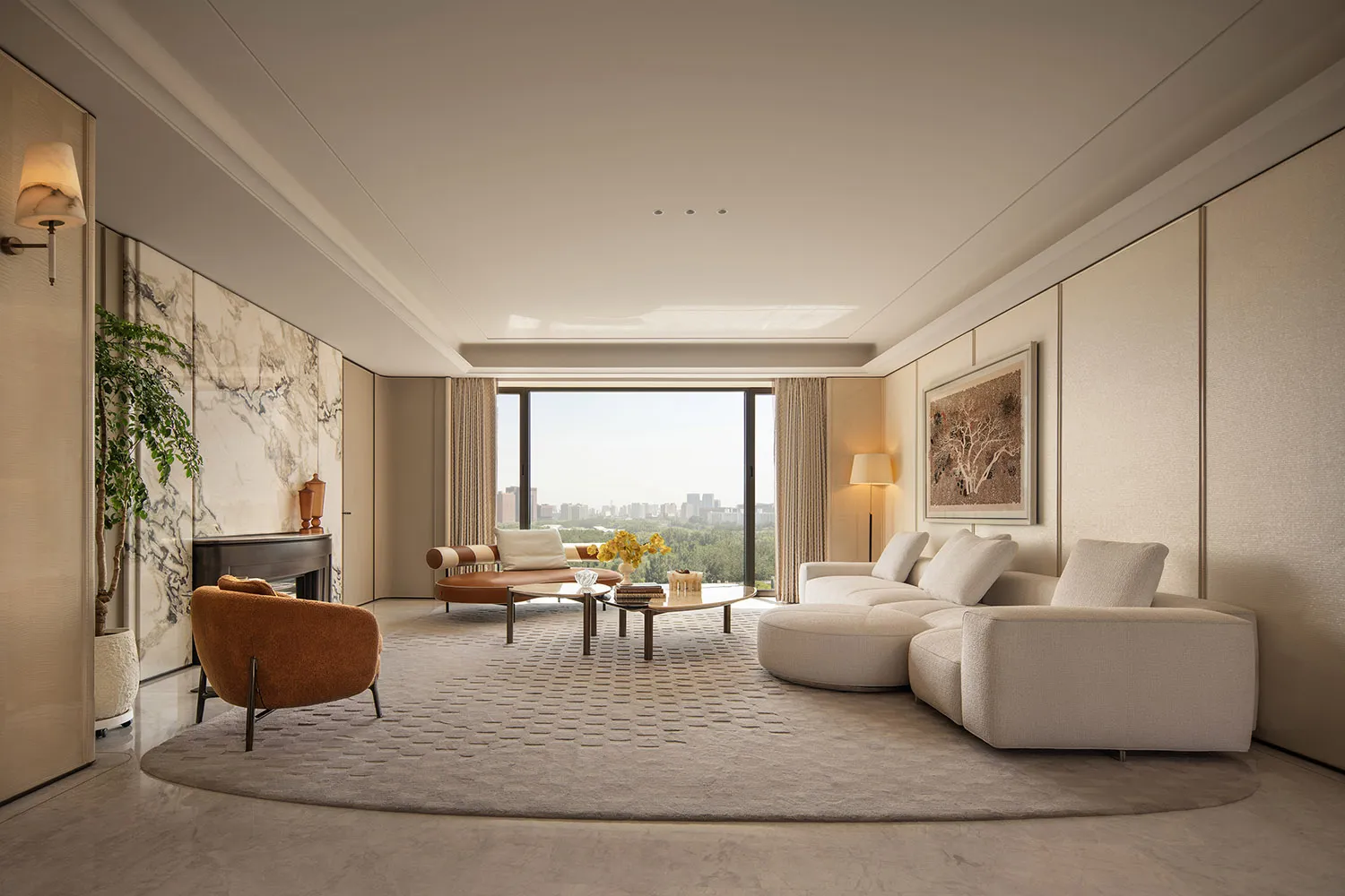 Modern luxury living room featuring a large curved off-white sectional sofa, burnt orange bouclé armchair, marble accent wall with fireplace, and floor-to-ceiling windows overlooking a city park.