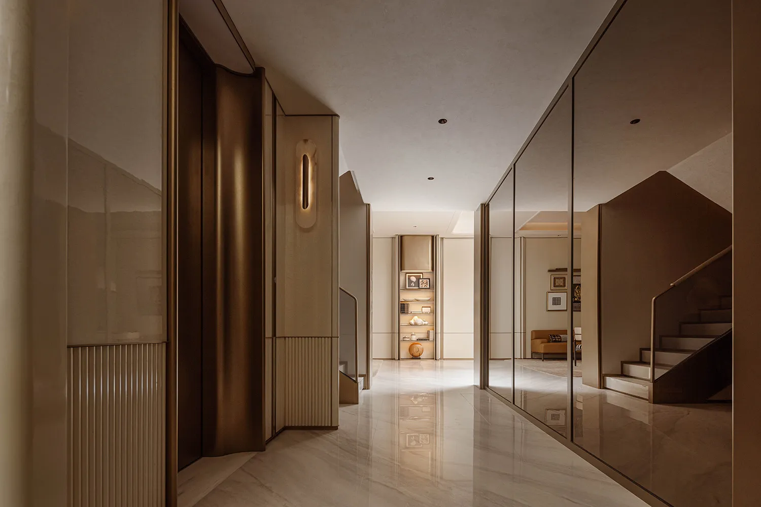 Modern luxury hallway with floor-to-ceiling brass mirrored cabinetry, fluted wall panels, polished marble floor, and integrated vertical lighting.