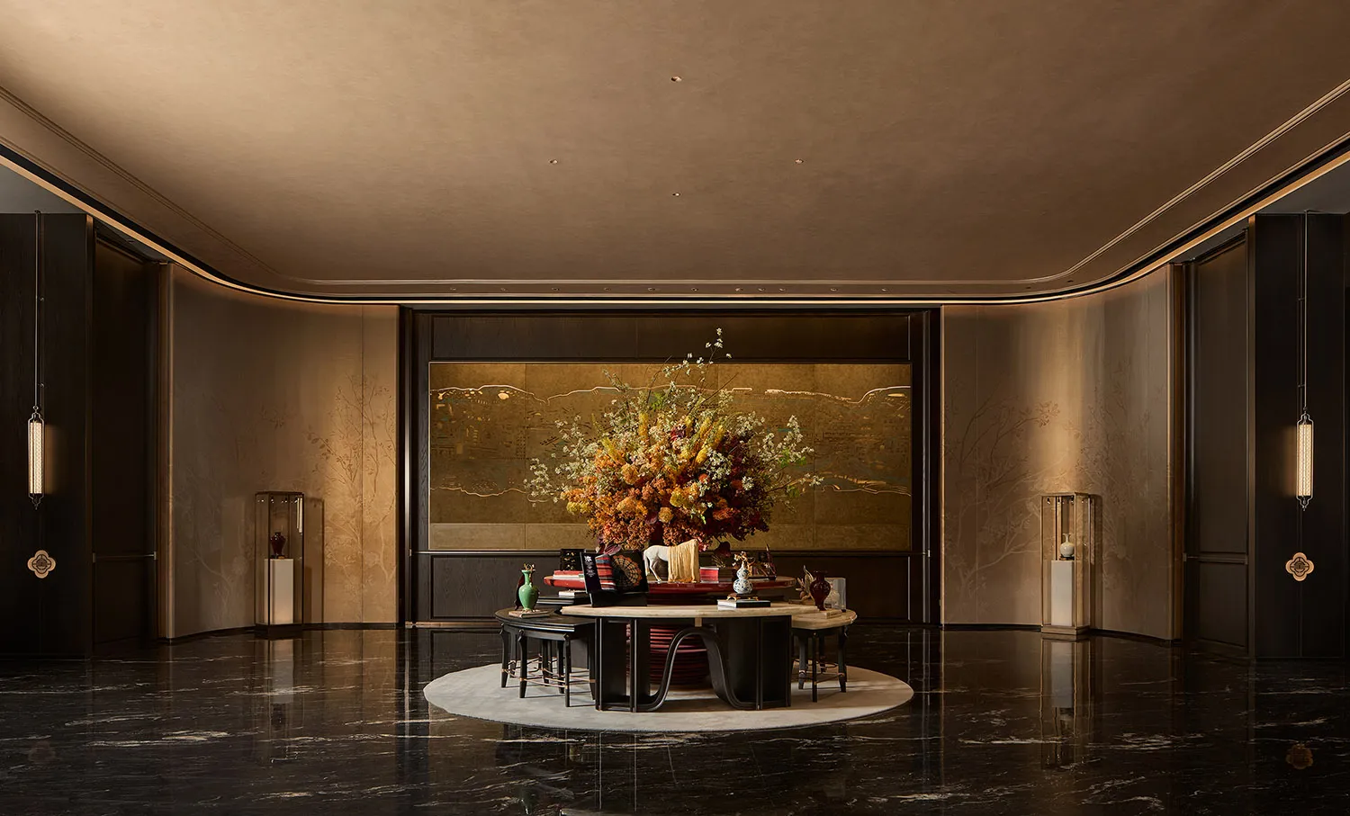 Elegant contemporary Chinese living room featuring a large round conversation area on a white rug, dramatic gilded folding screen, massive autumnal floral arrangement, and high-gloss black marble floor reflecting warm ambient lighting.