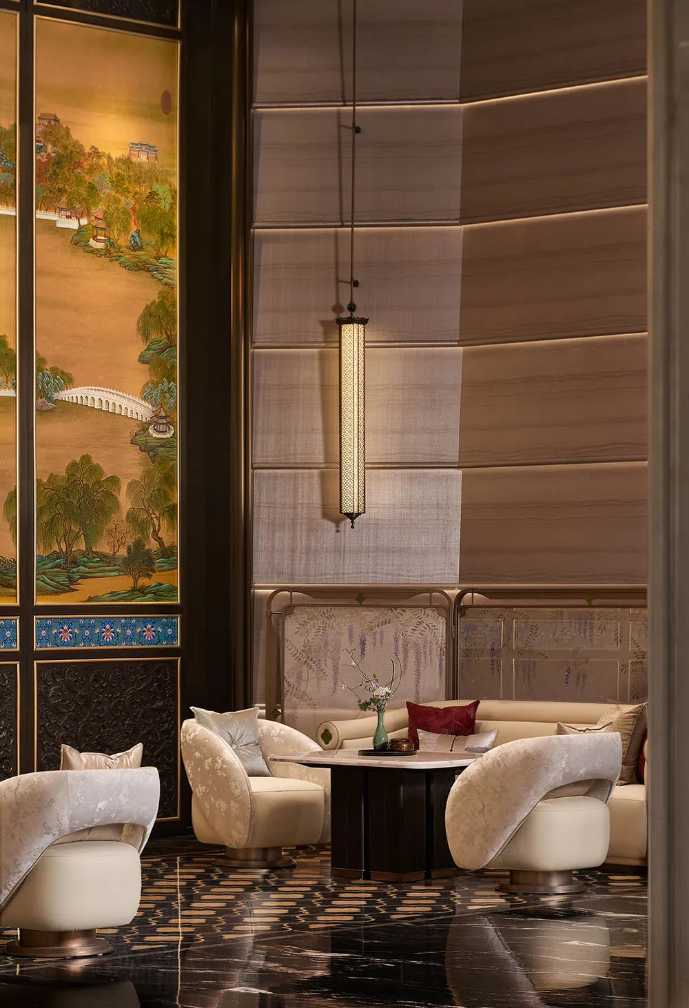 Luxurious Chinese-style lounge featuring cream velvet swivel armchairs, dark marble floor with gold inlay, traditional landscape screen, and elegant pendant lighting.