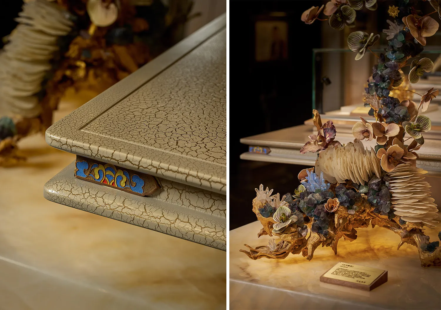 Close-up of a luxurious sculptural art piece featuring a beige crackle-glaze rectangular form with colorful traditional cloud pattern inlay, displayed beside an organic gilded sculpture adorned with crystal flowers and gemstones under warm lighting.