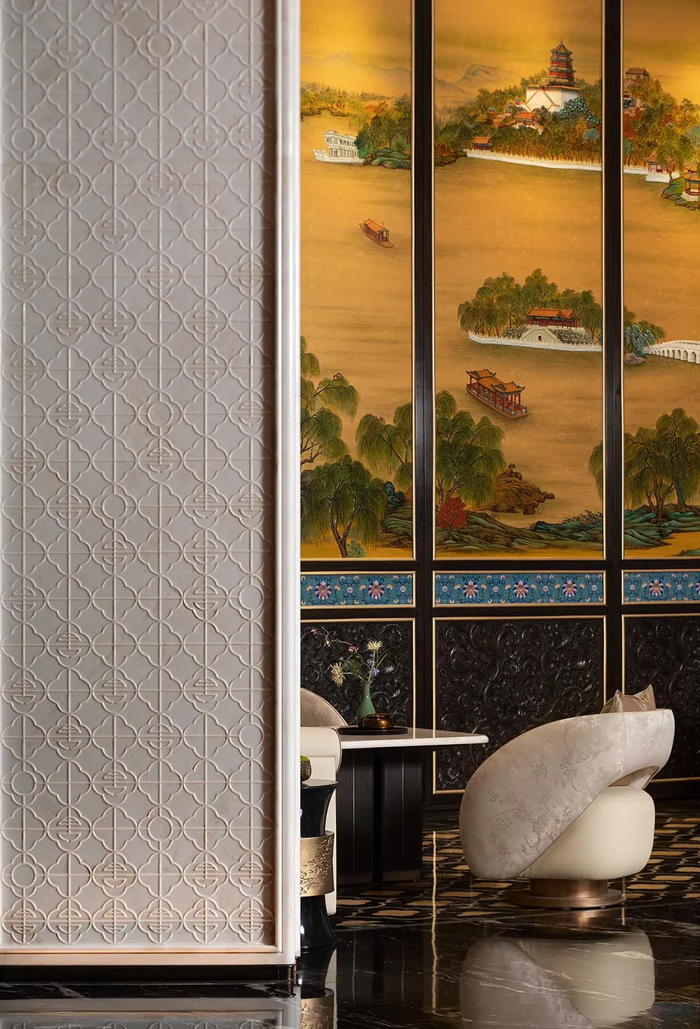 Modern Chinese-style living room featuring a large golden traditional landscape painting, white textured geometric wall, dark marble floor, and a cream sculptural swivel chair.