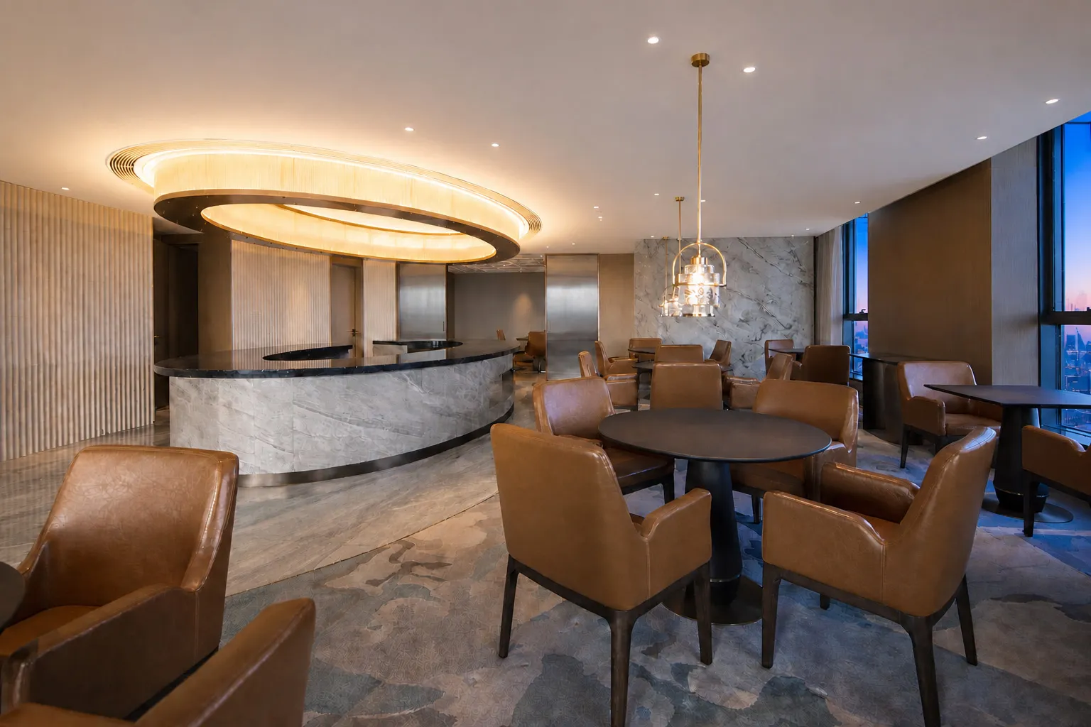 Modern luxury hotel lounge featuring a curved marble bar, cognac brown leather armchairs, round dining tables, and a striking circular pendant light fixture with warm ambient lighting.
