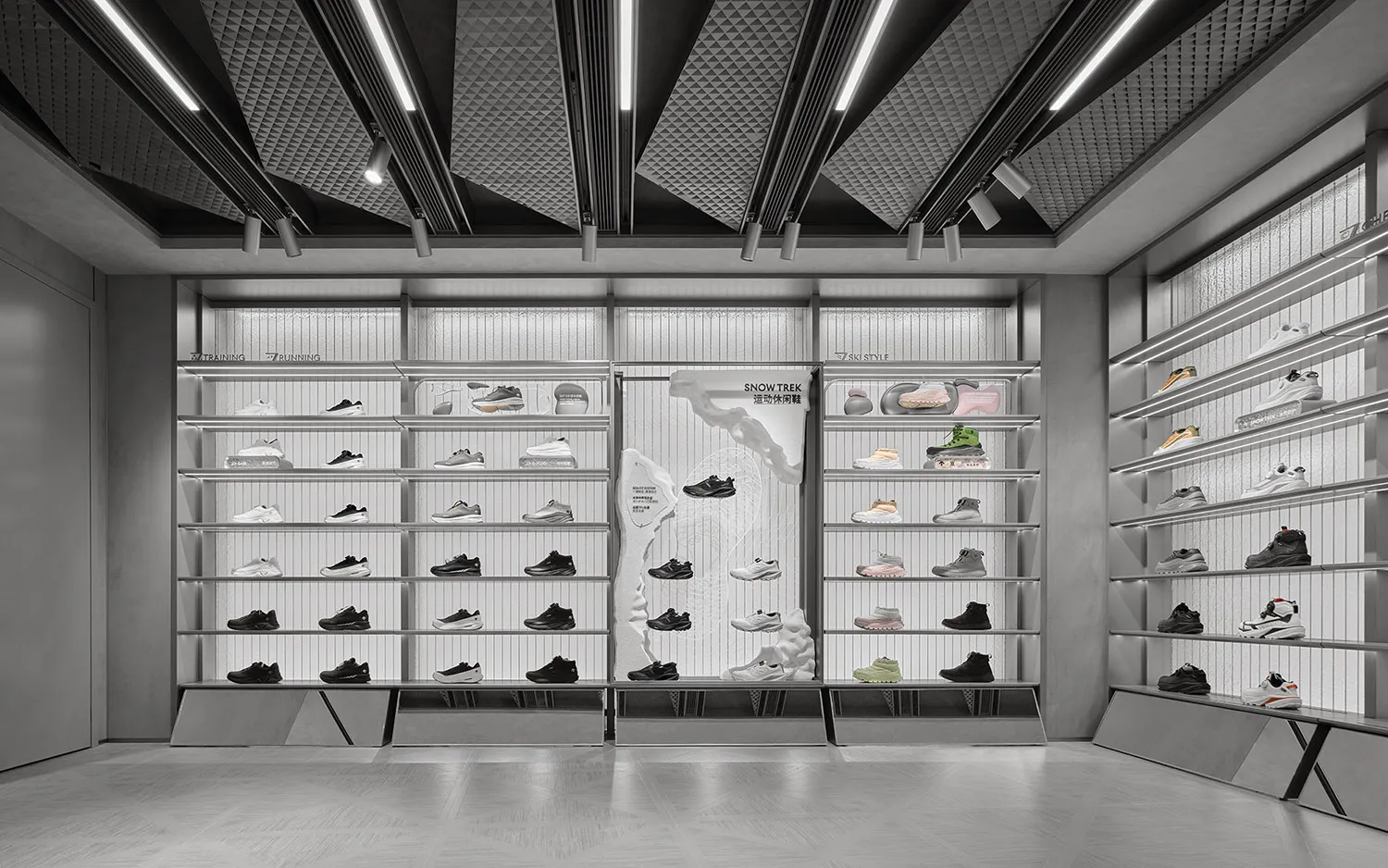 Modern monochrome retail store interior with extensive metal shelving displaying various athletic shoes, categorized by sport type under bright linear ceiling lights.