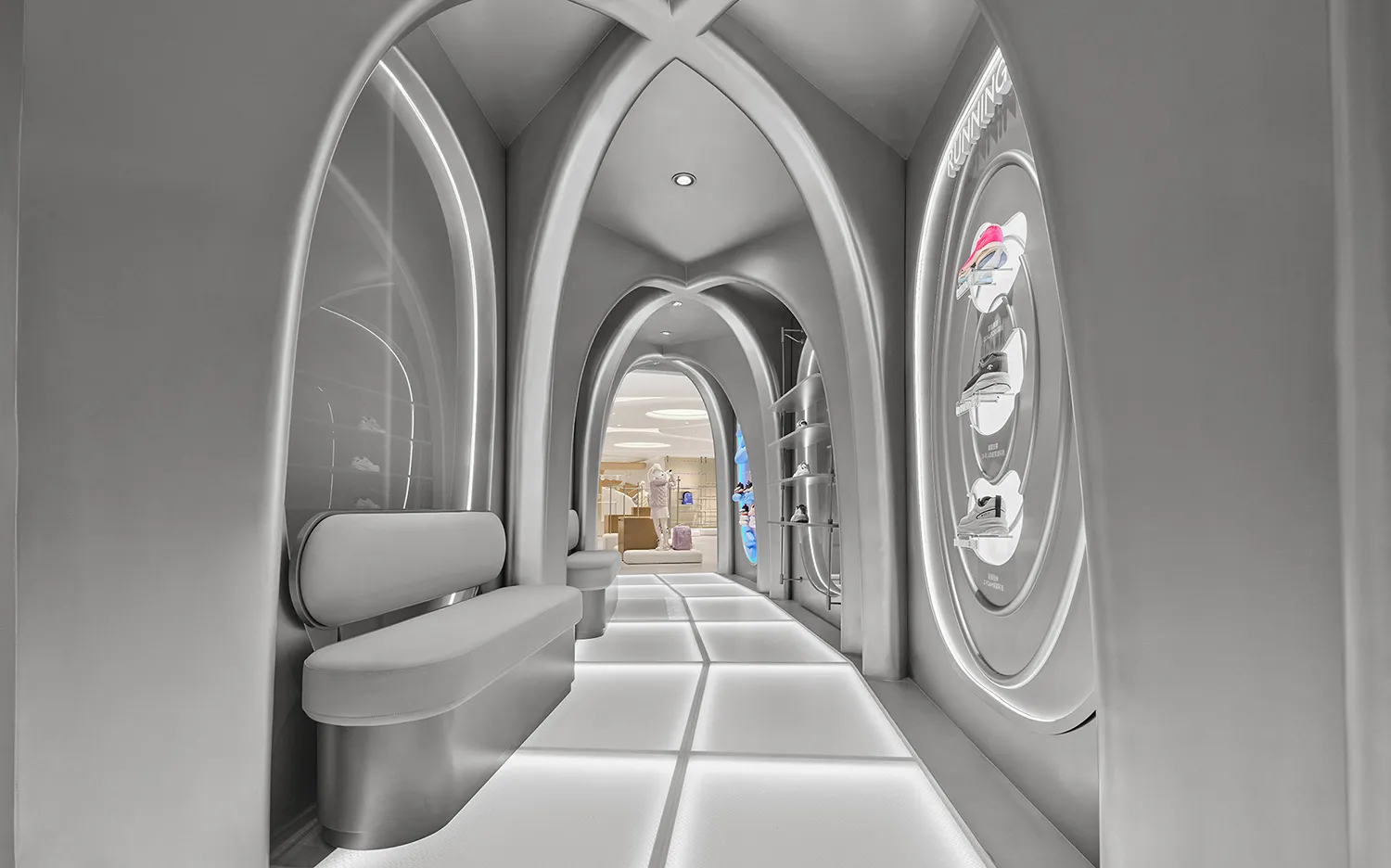 Modern futuristic shoe store interior featuring a long corridor with repeating white gothic arches, illuminated floor tiles, built-in seating, and circular shoe display on the right wall.