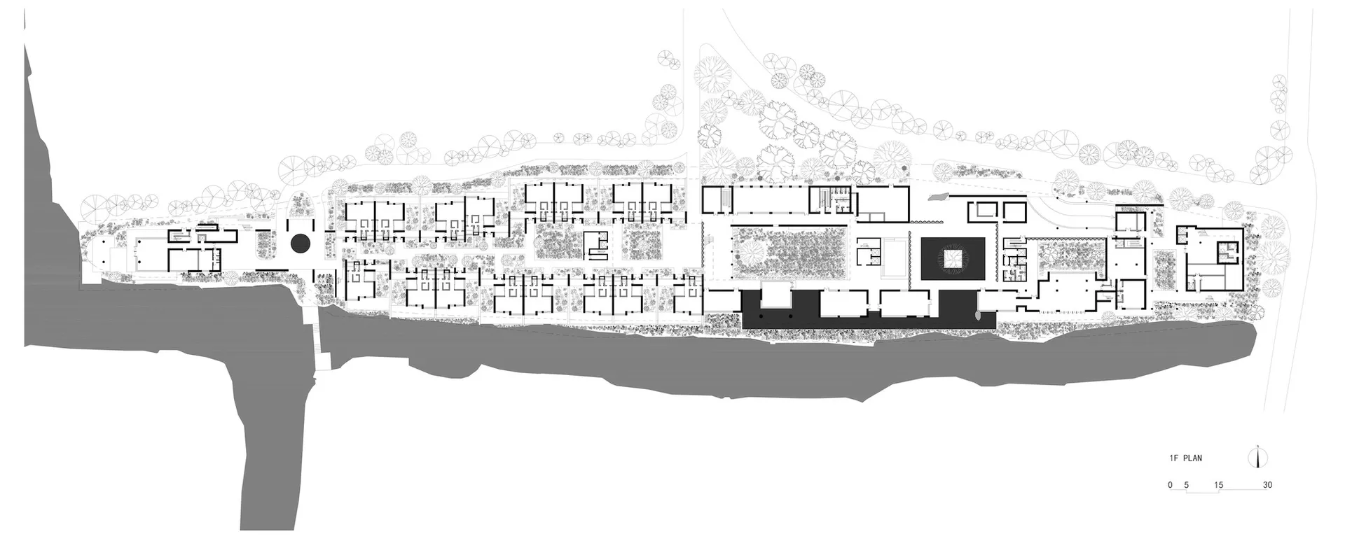 Black and white architectural 1F floor plan of a luxury resort complex situated along a riverbank, showing multiple buildings, courtyards, extensive landscaping, and a north arrow with scale.