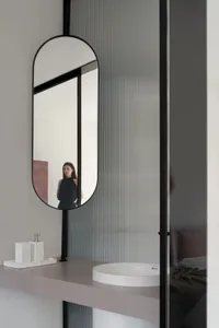 Modern bathroom interior with a glass faucet and minimalist design.