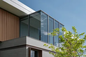 Modern building exterior featuring glass and concrete materials.