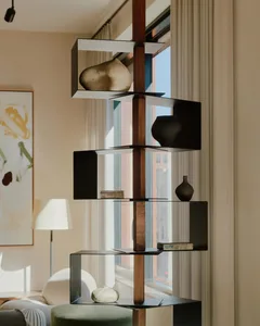 A modern living room featuring a sleek metal and wood shelf with various decorative objects.