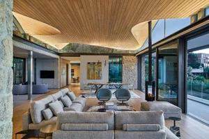 Contemporary living room with a gray sectional sofa, a modern coffee table, and a fireplace.