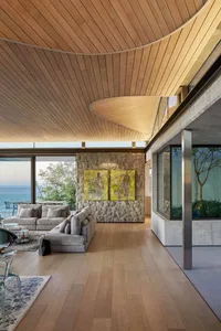Modern living room featuring wood, stone, and glass materials.