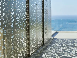 Modern outdoor space featuring a wall of metal perforated panels