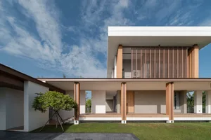 Modern residential architecture featuring a contemporary design with concrete, wood, and glass elements.