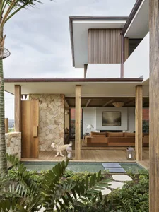 A modern residential interior featuring wood, stone, and metal elements.